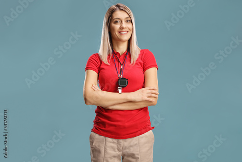 Female swimming coach with a wistle and stopwatch around her neck photo