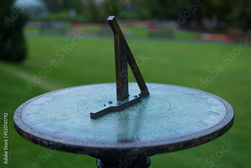 A sundial in a garden on a autumnal morning