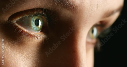 Eye, vision and woman zoom of blue and green eyes against a dark background. Macro view of Heterochromia, awareness and advertising of different, real people, optometry care or alternative beauty photo
