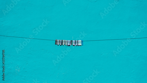 several clothespins hanging on a rope from a clothesline