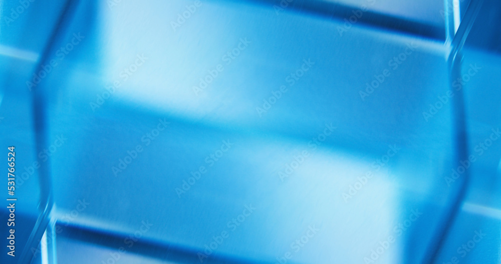 Defocused neon light. Glowing background for text. Fluorescent illumination. Blur tranquil blue white color reflection geometric abstract empty space wallpaper.