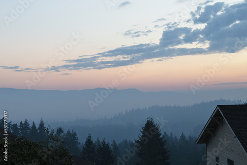 Fog combined with smoke from the Cedar Creek wildfire hang over Eugene, Oregon in the early morning hours of September 19, 2022. photo