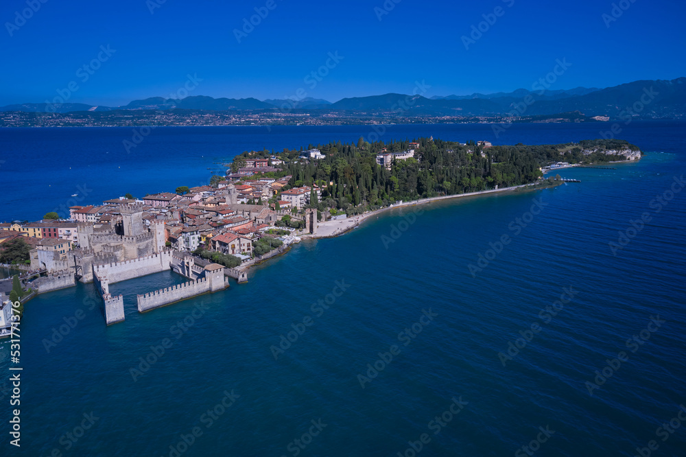 An ancient village on southern Garda Lake. Aerial view on Sirmione sul Garda. Italy, Lombardy. View by Drone. Rocca Scaligera Castle in Sirmione.