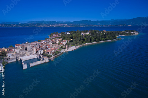 Wallpaper Mural An ancient village on southern Garda Lake. Aerial view on Sirmione sul Garda. Italy, Lombardy. View by Drone. Rocca Scaligera Castle in Sirmione. Torontodigital.ca