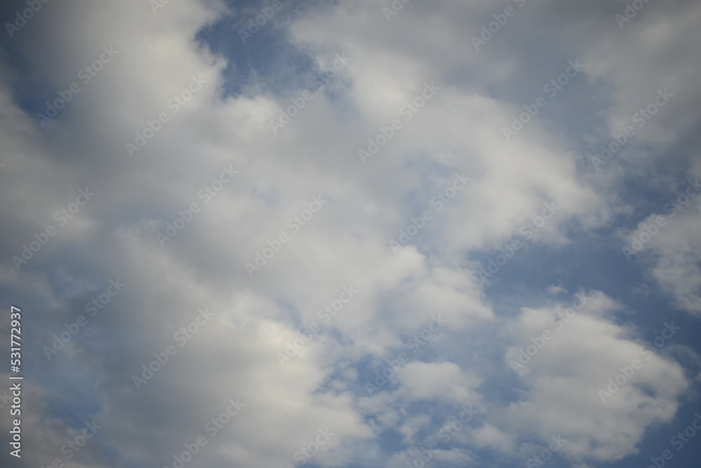 Obraz premium autumn ukrainian blue sunny sky with round white-black cirrus clouds background texture sky in ukraine gradient white blue color