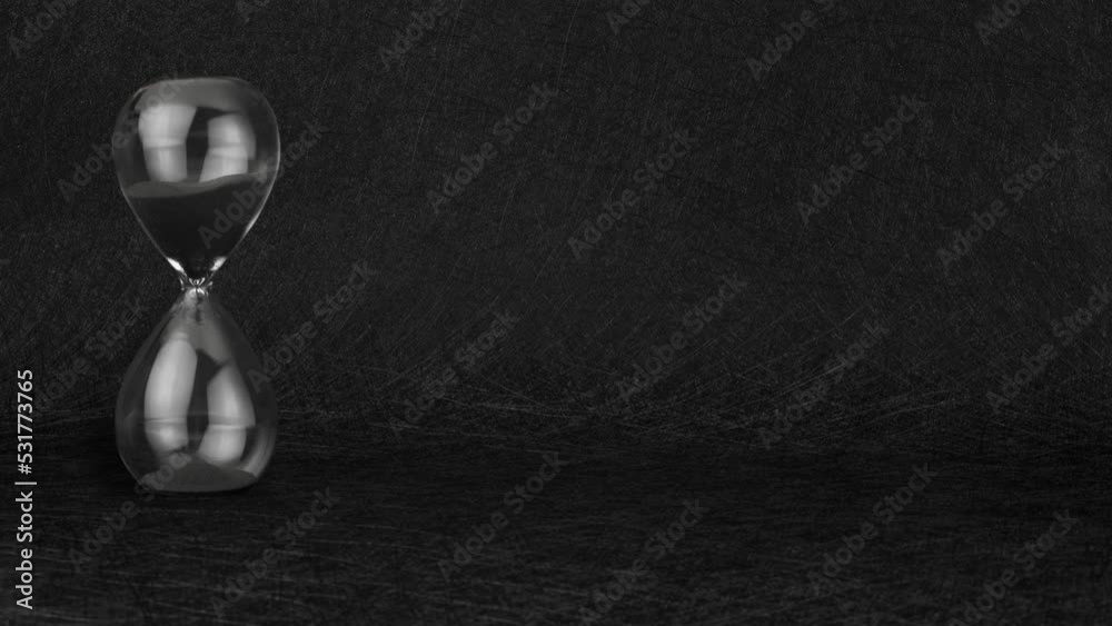 Black sand clock timer hourglass on black textured background.
Sandglass egg timer. Time flies chronograph sands of time. Deadline approaching. Time is running out. Nice copy space!