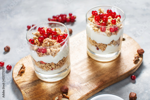 Healthy breakfast menu concept. Morning granola breakfast with berries served with yogurt in glasses