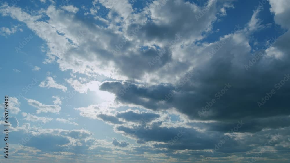 Amazing white fluffy clouds moving softly on bright blue sky. Change of weather. Timelapse.
