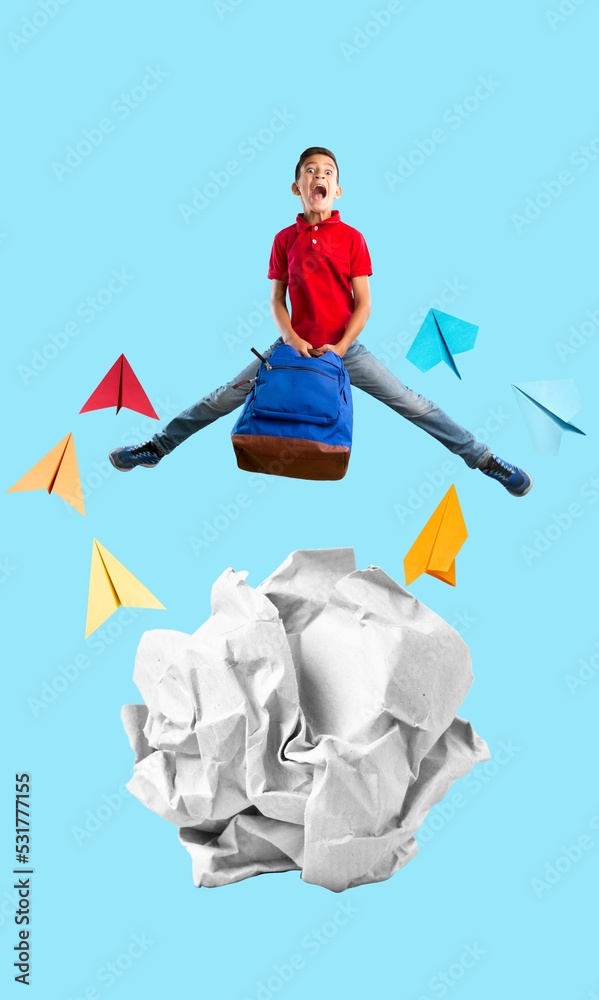 Positive child stand on crumpled paper with toy plane
