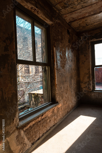 Abandoned building. An abandoned building illuminated by sun at daytime.