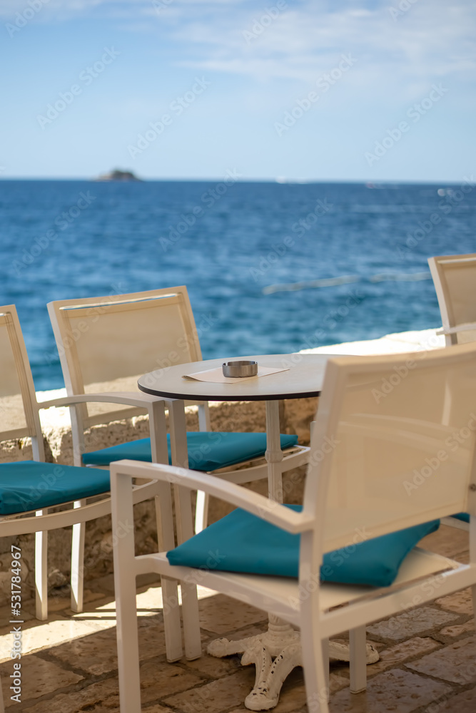 close up of table setting at open-air cafe on beach