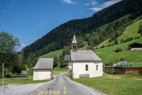 A church divided in two by a road. The location is in Trentino, Italy.