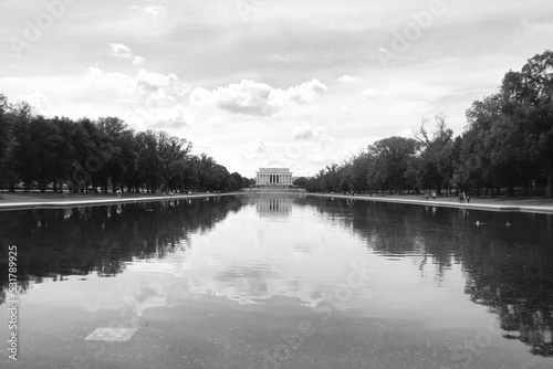 Grayscale landscape image of the Lincoln Memorial from across the Reflecting Pool