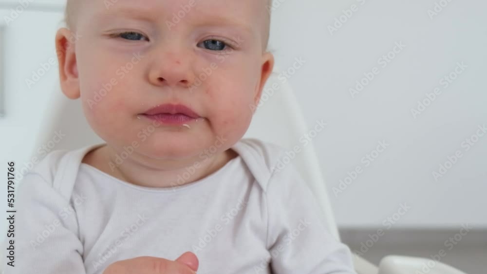 Young baby expressively chewing. Cute cheerful child close up portrait. Slow motion video Young baby expressively chewing. Cute cheerful child close up portrait. Slow motion video