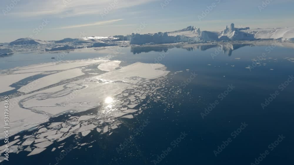 Ice And Calm Sea Surface Reflecting Bright Sunlight Ice And Calm Sea Surface Reflecting Bright Sunlight