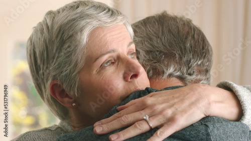 Love, support and hug with a senior couple hugging to care, console or give comfort after loss, grief and pain. Problem, lifestyle and marriage with a mature couple embrace with a sad expression photo