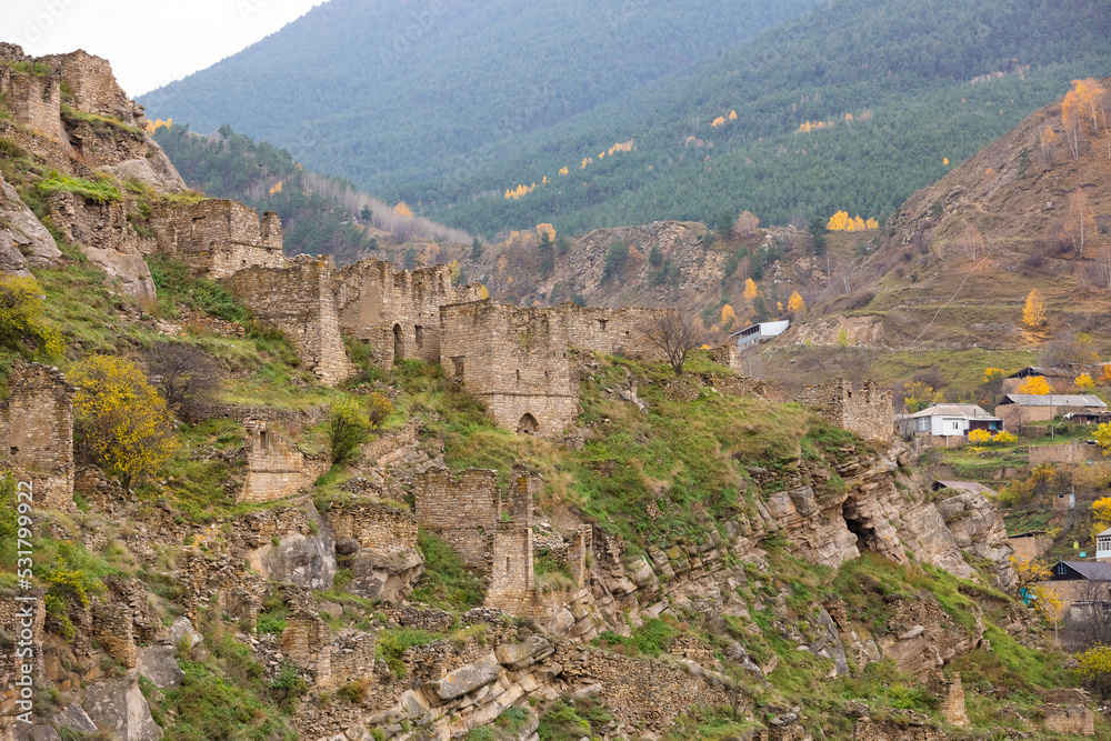 Fototapeta premium Old stone town Kakhib, Dagestan, Russia. Ancient towers, ruins and houses on the rocks. Panoramic view of the city on the mountains