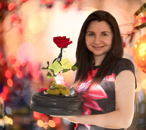 Woman holds eternal rose with wishes 