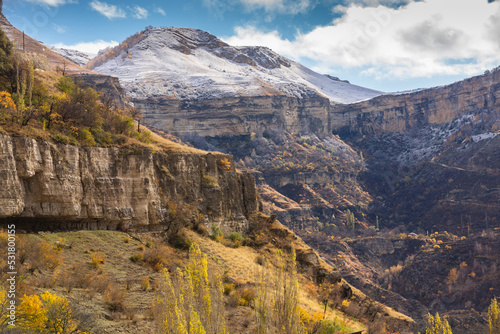 Fantastic high rocks. Autumn landscape with steep mountain peaks in snow. Caucasus Mountains in Gunib, Dagestan, Russia. Panoramic view of the Caucasian ridges and sharp rocks