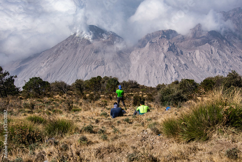 Hikers at Santiaguito lava dome erupting off Santa Maria volcano, Quetzaltenango, Guatemala photo