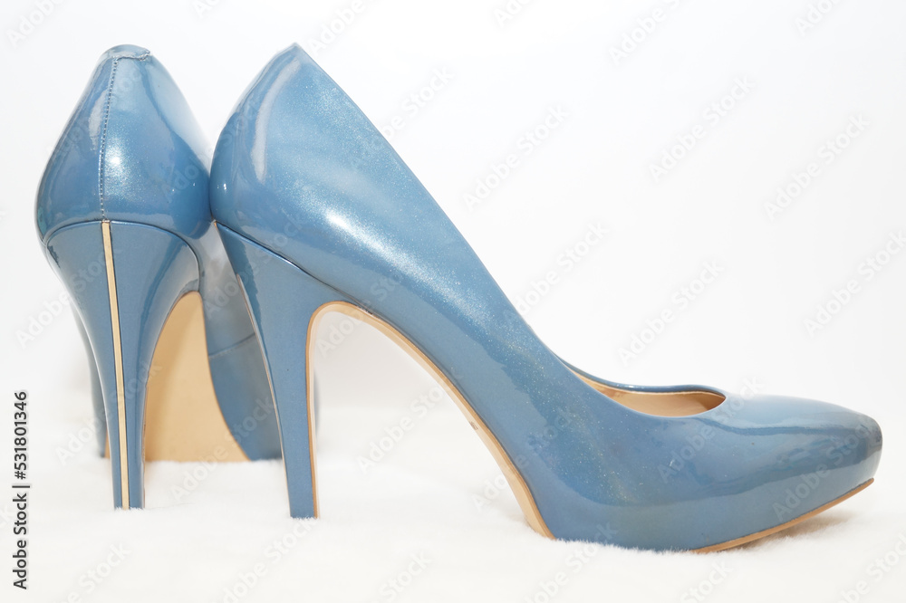 Obraz premium Blue sexy high-heeled shoes isolated on a white carpet.
