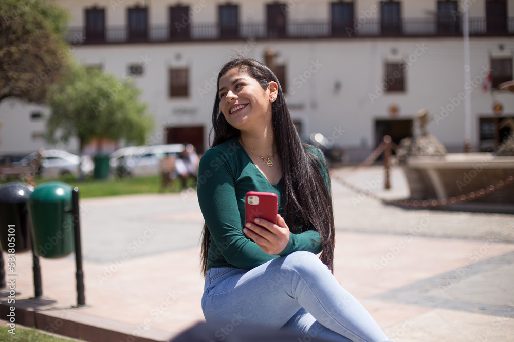 Fototapeta premium Young woman enjoying her day off in a city park. Concept of mental health, lifestyle.