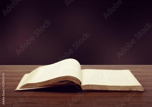 Big open book on a desk for reading concept photo