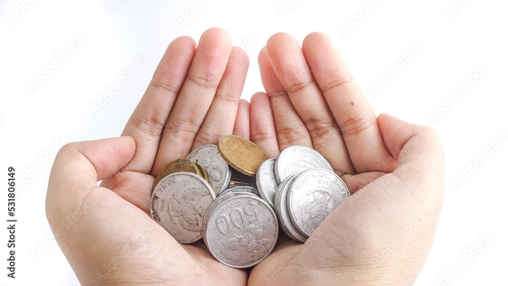 Close up Indonesian Coins in hands. Selective Focus. give a stack of coin with both hands Close up Indonesian Coins in hands. Selective Focus. give a stack of coin with both hands
