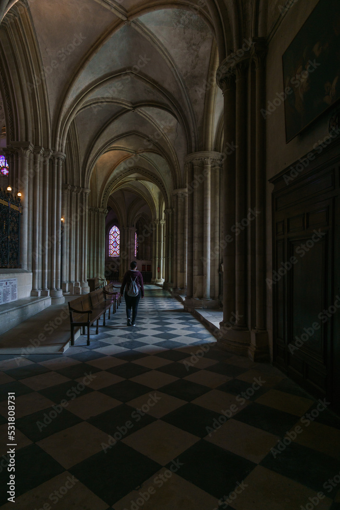 Obraz premium Woman wallking inside the men's abbey l'Abbaye-aux-Hommes, Caen, Normandy, France