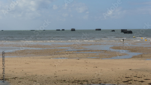The ruins of artificial port of Gold beach on sunny summer day in Asnelles, Normandy, France