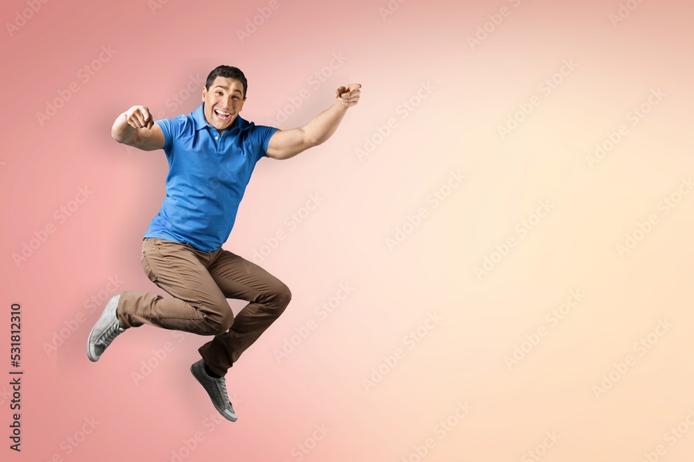 Young man jump on pastel background