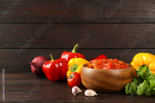 Tasty lecho and fresh ingredients on wooden table. Space for text