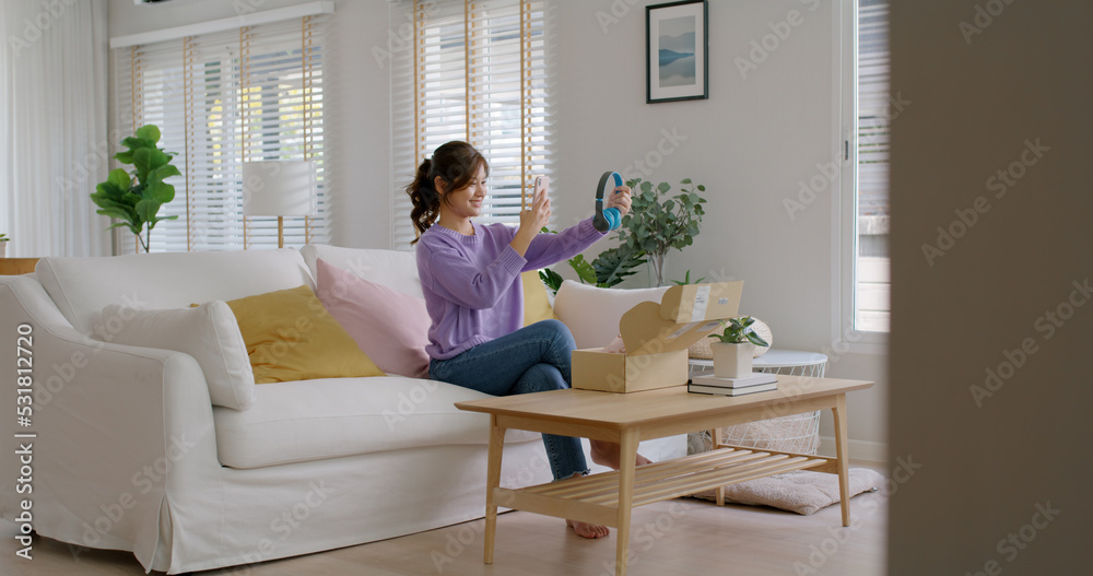 Young asia people happy teen girl influencer smile unbox open gift box enjoy buy order online store shop photo shooting camera show post social media app blog vlog share sit relax at home sofa couch. Young asia people happy teen girl influencer smile unbox open gift box enjoy buy order online store shop photo shooting camera show post social media app blog vlog share sit relax at home sofa couch.
