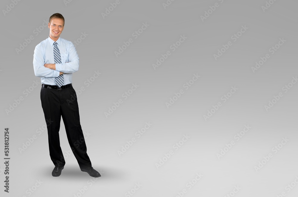 Young businessman standing and posing on background, Young businessman standing and posing on background,