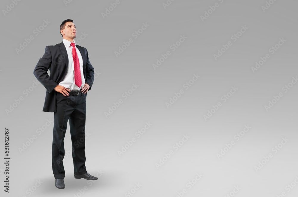 Young businessman standing in suit and posing on background, Young businessman standing in suit and posing on background,