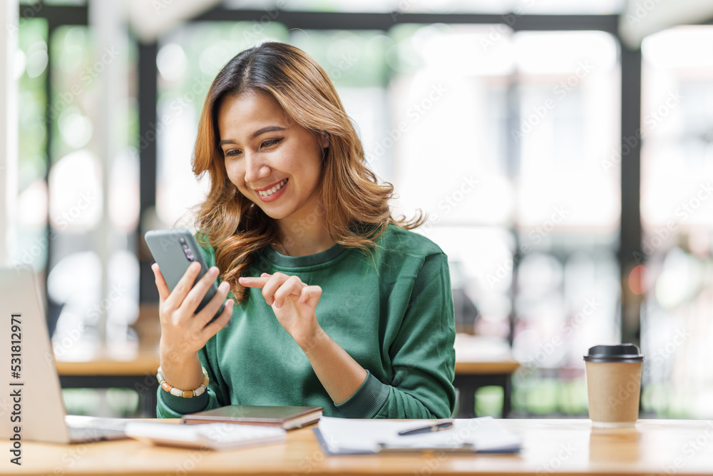 Successful asian woman entrepreneurs using mobile start up grow their businesses with mobile, application and technology concept.