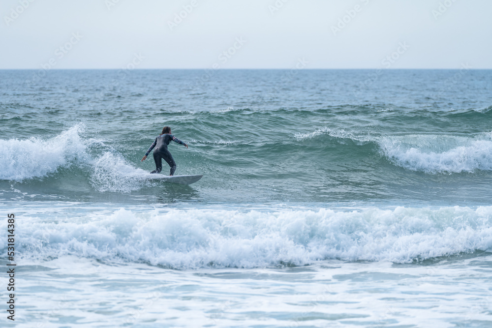 Surfer girl riding a wave