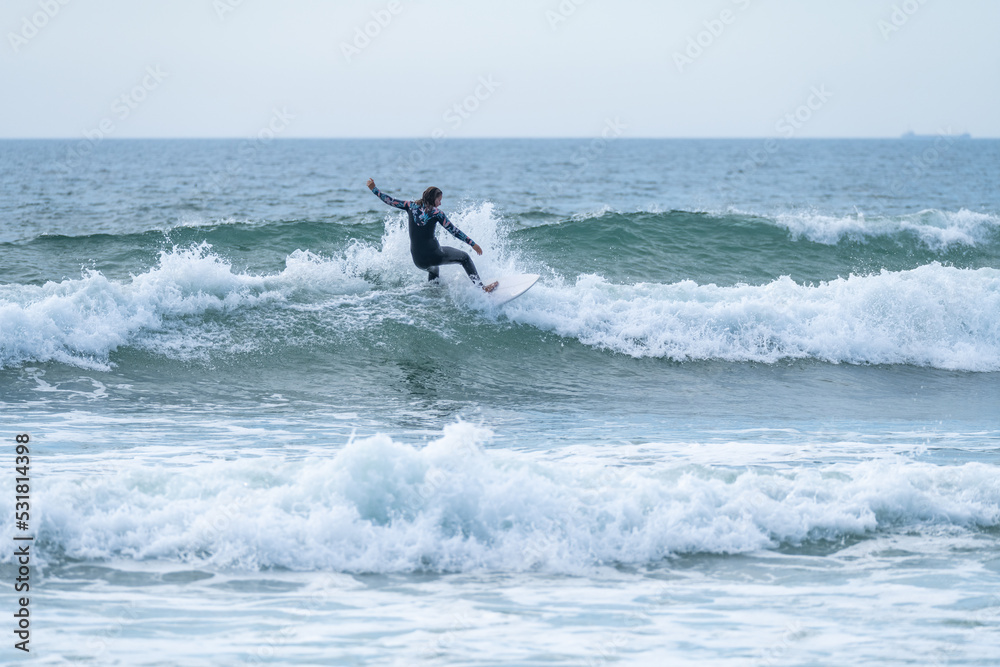 Surfer girl riding a wave