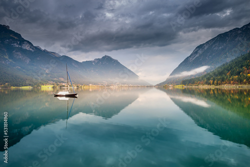 Sailboats in Achensee lake near Innsbruck at peaceful dawn, Tyrol alps, Austria