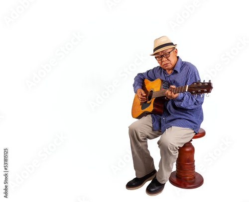 Studio portrait of asian senior man with hat playing guitar on white  background and space