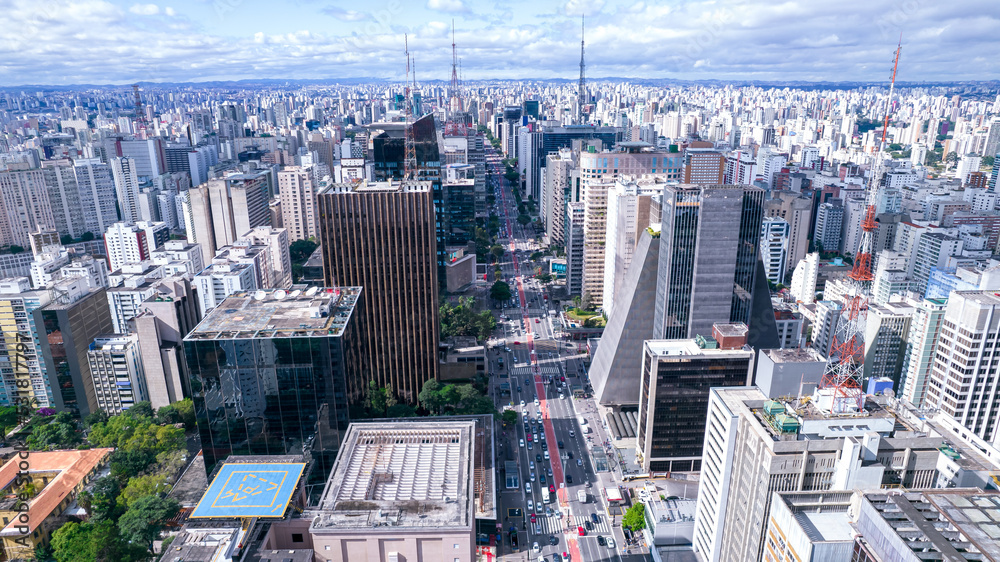 Fototapeta premium Aerial view of Av. Paulista in São Paulo, SP. Main avenue of the capital. With many radio antennas, commercial and residential buildings. Aerial view of the great city of São Paulo.