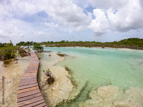 Boardwalk across the clear water and stromatolites in Bacalar photo