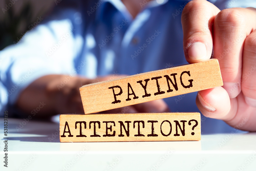 Wooden blocks with words 'Paying Attention?'. Wooden blocks with words 'Paying Attention?'.