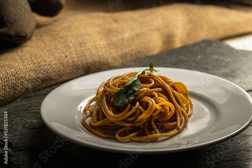 delicious noodles with putanesca tomato sauce photo