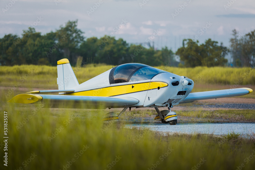 commercial airport for private small planes that can be used to practice flying to become a trainee pilot to fly to travel, deliver goods, or fly as a hobby There is a machine on orange and yellow commercial airport for private small planes that can be used to practice flying to become a trainee pilot to fly to travel, deliver goods, or fly as a hobby There is a machine on orange and yellow
