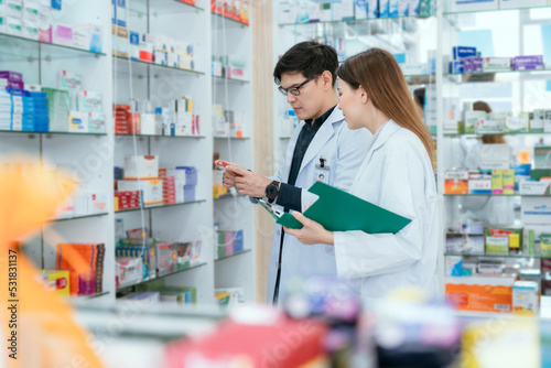 Male and female pharmacists talk to check stocks of medicines in pharmacies. communication