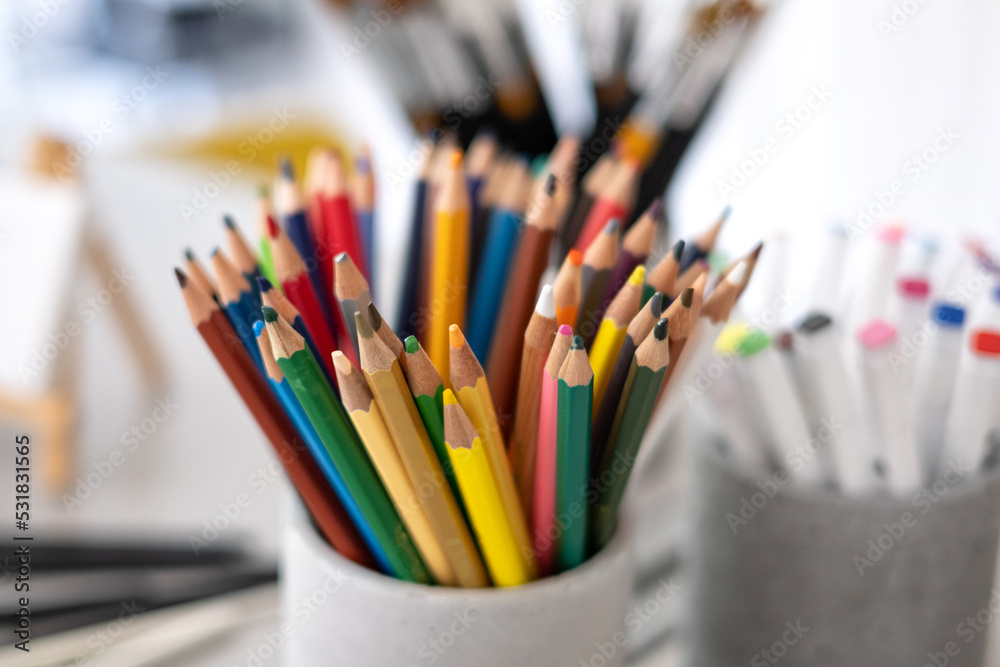A set of tools of the artist, creator, colored pencils, brushes, artistic creative studio A set of tools of the artist, creator, colored pencils, brushes, artistic creative studio