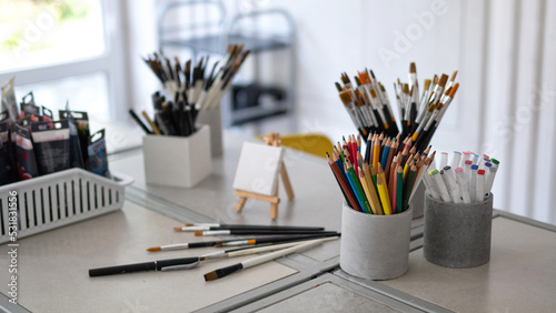 A set of tools of the artist, creator, colored pencils, brushes, artistic creative studio