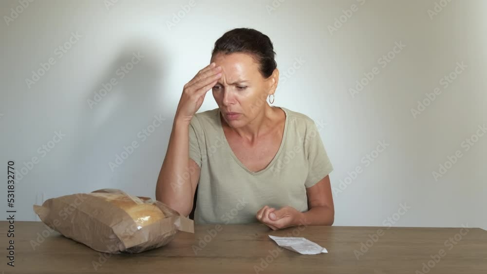 Inflation and rising prices for meal. A pensive woman with coins in her hands think about expensive prices on food in the world. Inflation and rising prices for meal. A pensive woman with coins in her hands think about expensive prices on food in the world.