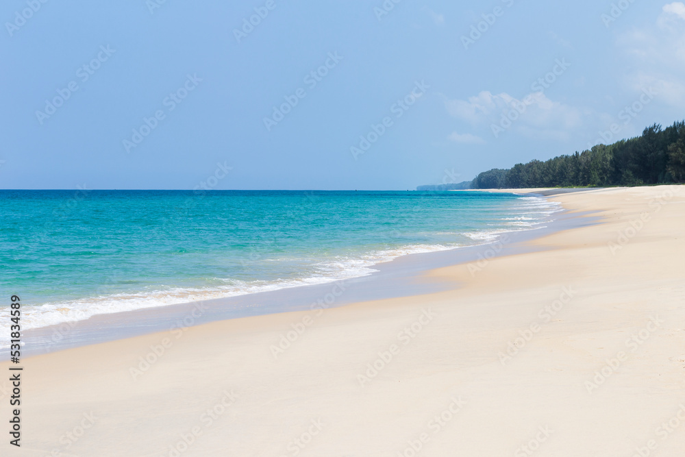 Tropical beach background, clean sandy beach with blue sea background, summer outdoor day light